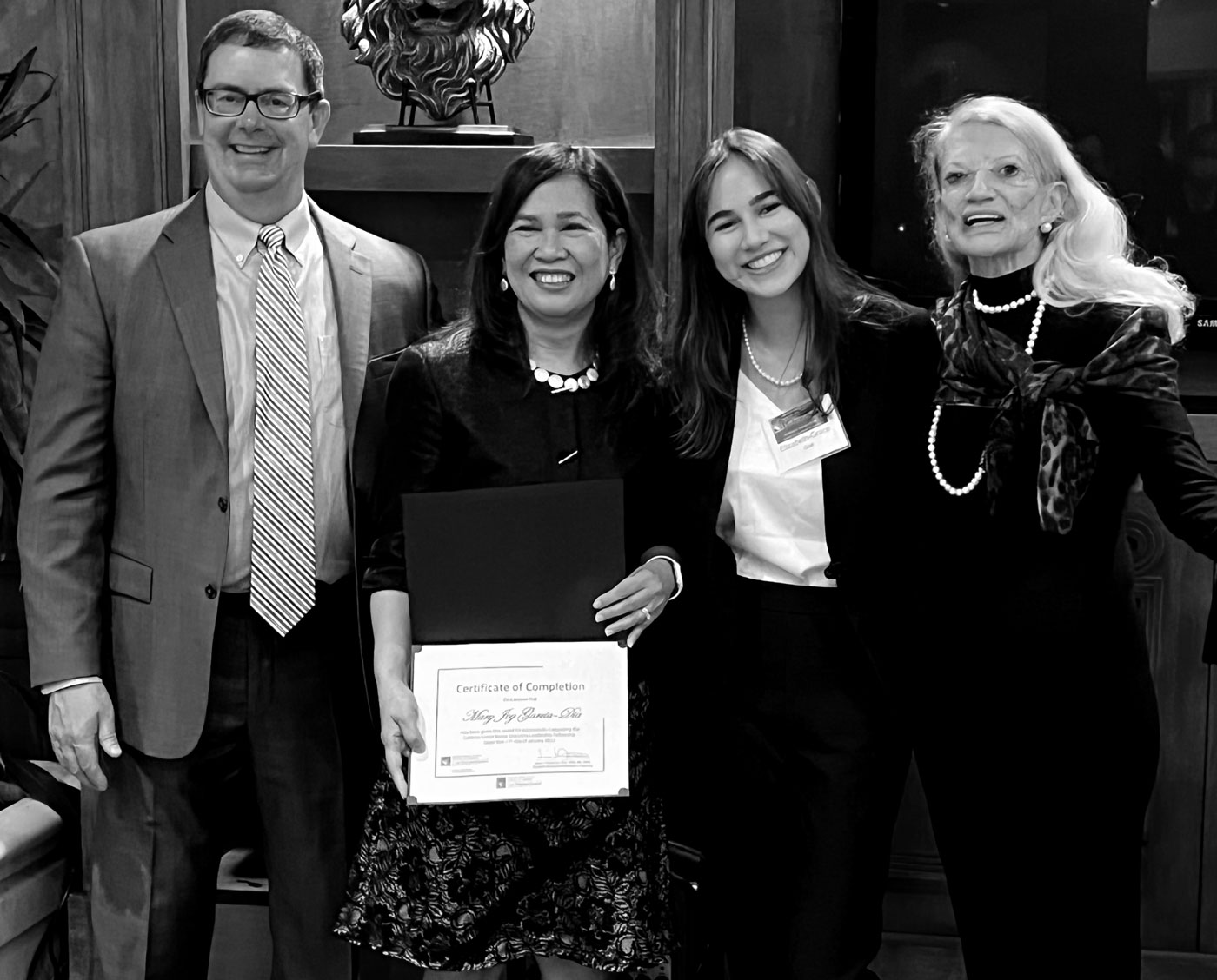 piacture of Elizabeth-grace presenting Dr. Mary Joy Garcia-Dia the Coldiron x Justly Fellowship
